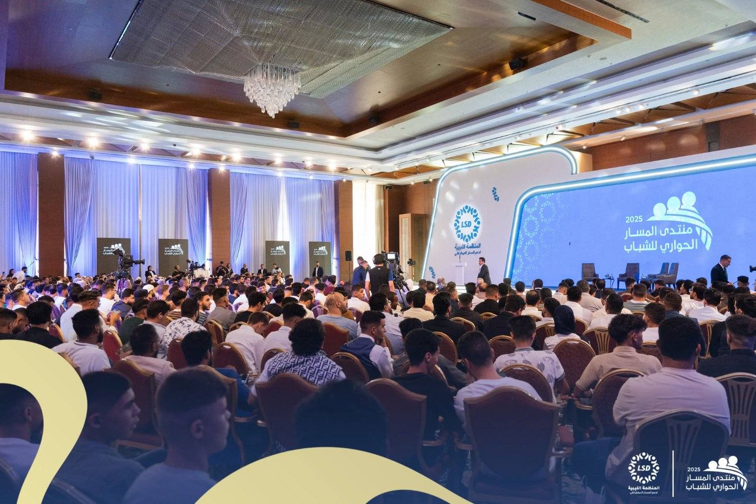 A speaker addresses the forum